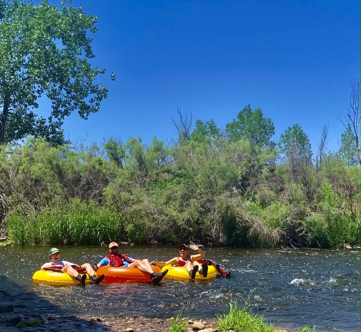 3 people tubing south platte